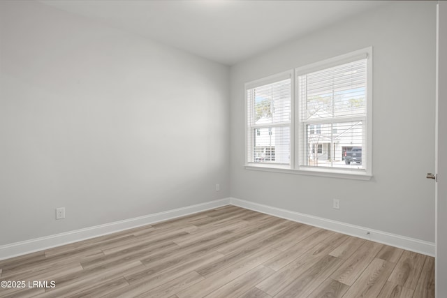 unfurnished room with light wood-style floors and baseboards