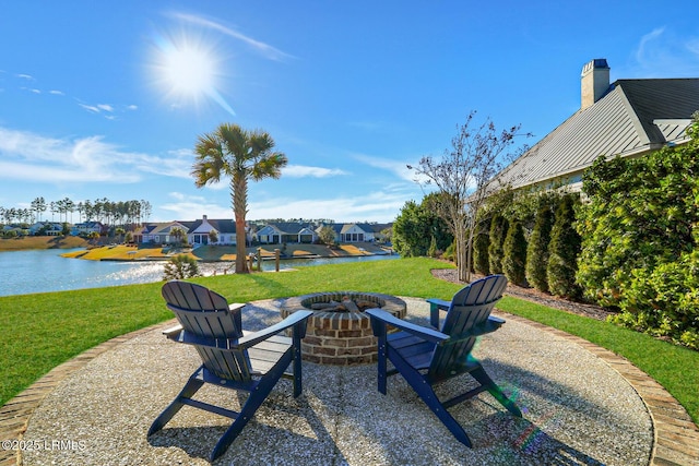 view of yard with a patio area, a water view, a residential view, and an outdoor fire pit