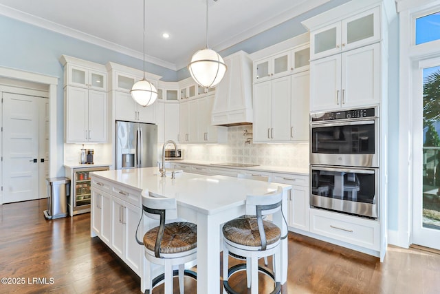 kitchen with backsplash, appliances with stainless steel finishes, white cabinets, and light countertops