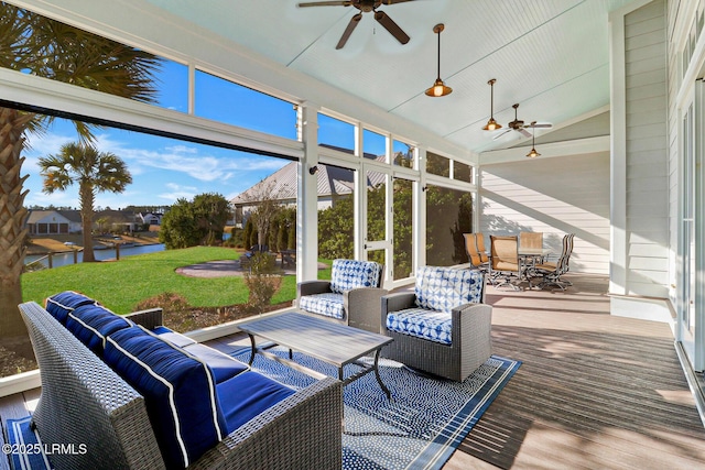 sunroom featuring a wealth of natural light, lofted ceiling, and a ceiling fan