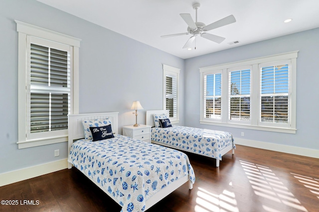 bedroom featuring visible vents, baseboards, and dark wood finished floors