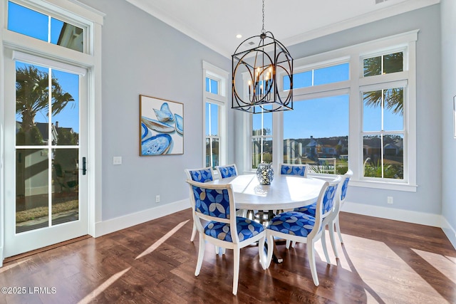 dining space featuring dark wood-style floors, a notable chandelier, and baseboards