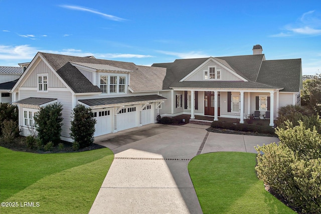 view of front of house with driveway, a porch, board and batten siding, a front yard, and a chimney