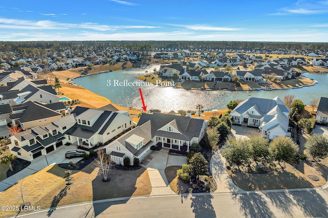 birds eye view of property featuring a residential view and a water view