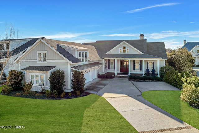 view of front of property with board and batten siding, a porch, concrete driveway, a front yard, and roof with shingles