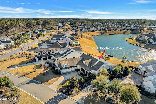 drone / aerial view with a residential view and a water view