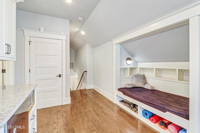 corridor featuring visible vents, an upstairs landing, recessed lighting, light wood-style floors, and vaulted ceiling