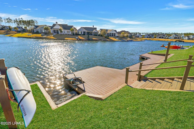 dock area featuring a lawn, a residential view, and a water view