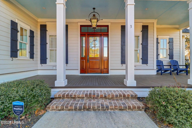 view of exterior entry featuring a porch