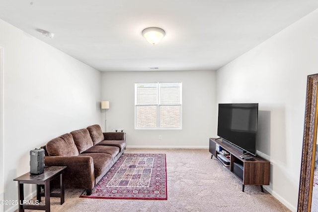 carpeted living room featuring baseboards