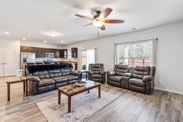 living room featuring ceiling fan, recessed lighting, visible vents, baseboards, and light wood-style floors