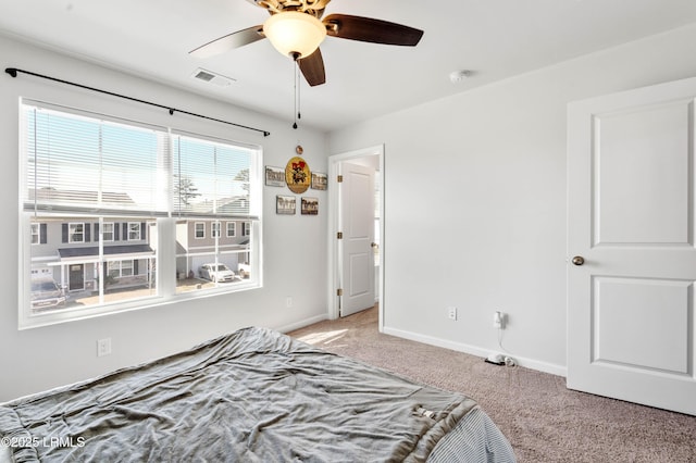 unfurnished bedroom with carpet floors, baseboards, visible vents, and ceiling fan