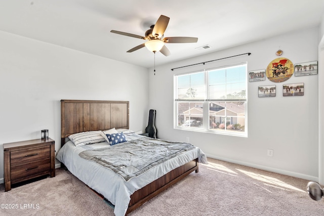 bedroom featuring light carpet, ceiling fan, visible vents, and baseboards