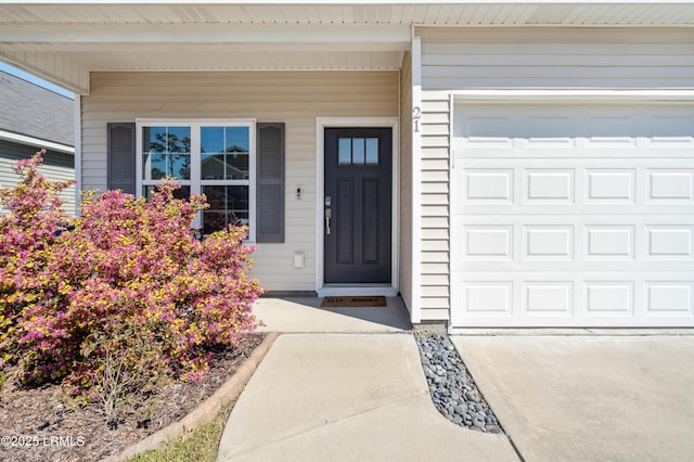 view of exterior entry featuring a garage