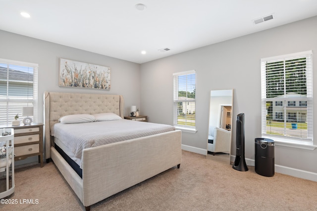 bedroom with recessed lighting, visible vents, light carpet, and baseboards