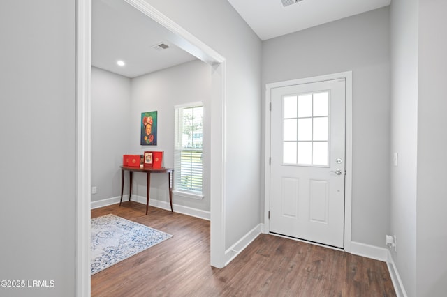 entryway featuring wood finished floors, visible vents, and baseboards