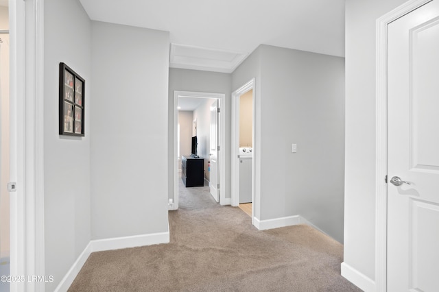 hall featuring carpet floors and baseboards