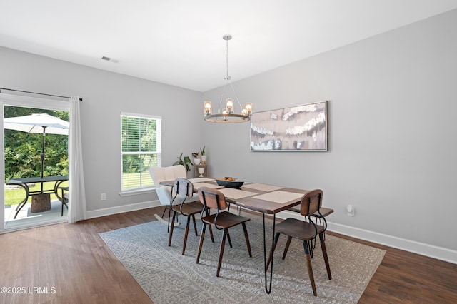 dining area with visible vents, baseboards, and wood finished floors