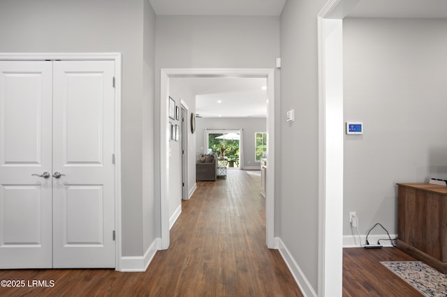 hallway with dark wood-style floors, recessed lighting, and baseboards