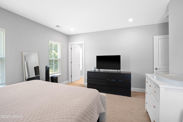 bedroom with light carpet, recessed lighting, visible vents, and baseboards