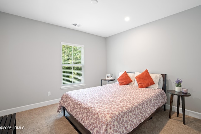 carpeted bedroom with baseboards and visible vents