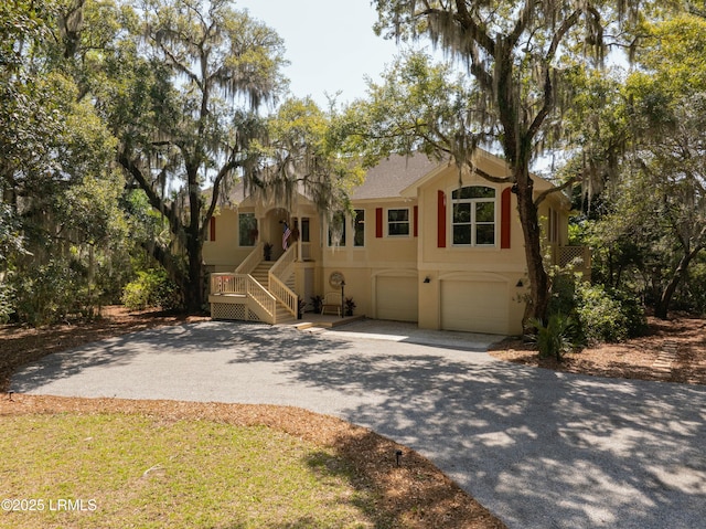 2 S Oak Forest Dr, Okatie, SC 29909 - ranch-style home with driveway, an attached garage, stucco siding, and stairs