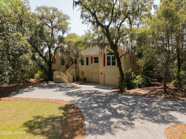 2 S Oak Forest Dr, Okatie, SC 29909 - ranch-style house featuring stairs, concrete driveway, a garage, and stucco siding