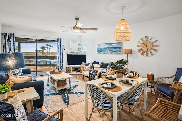 dining area with hardwood / wood-style flooring and ceiling fan