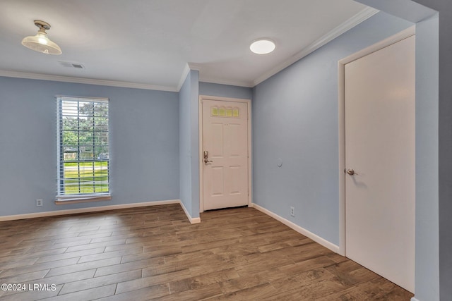 foyer entrance with wood-type flooring and crown molding