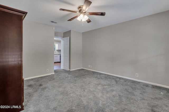 carpeted spare room with ceiling fan