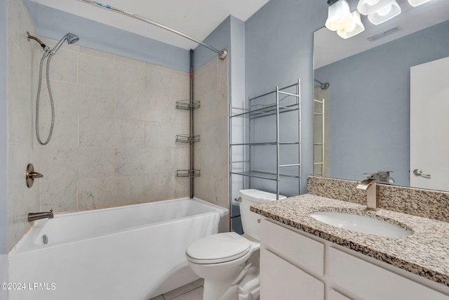 full bathroom with tiled shower / bath, vanity, and toilet