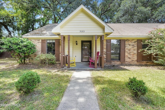 bungalow-style house featuring a porch and a front yard