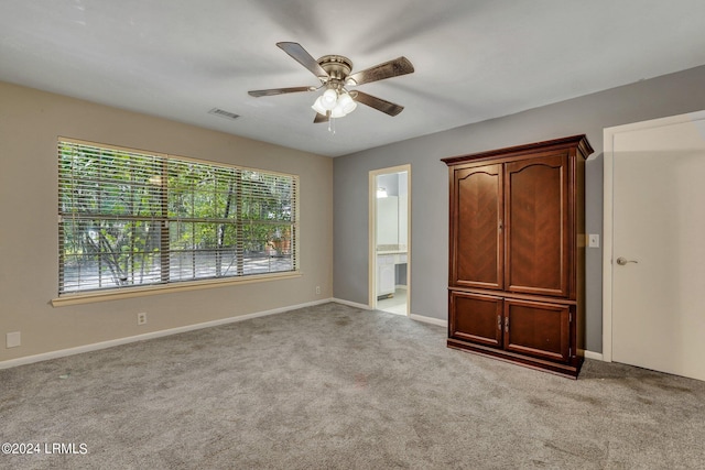 interior space with ceiling fan