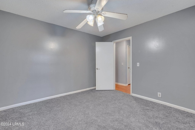 empty room featuring carpet flooring, a textured ceiling, and ceiling fan