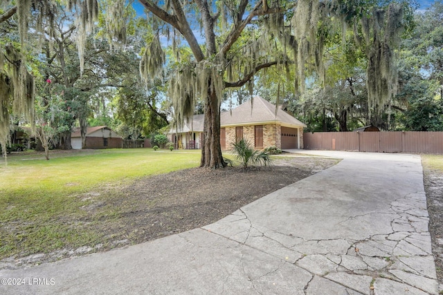 view of front of property with a garage and a front lawn