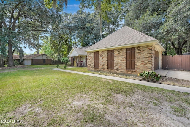 ranch-style home with a garage and a front yard