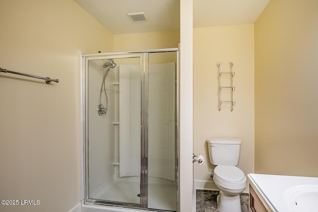 bathroom with a shower with door, vanity, and toilet