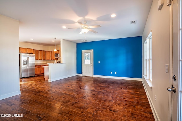 unfurnished living room featuring dark hardwood / wood-style floors and ceiling fan