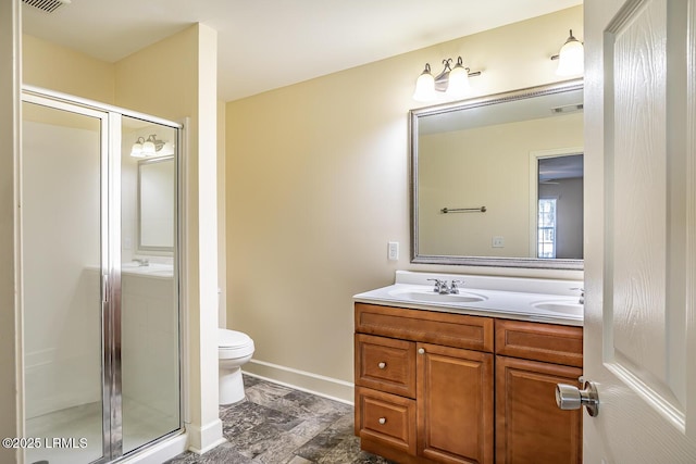 bathroom featuring vanity, toilet, and walk in shower