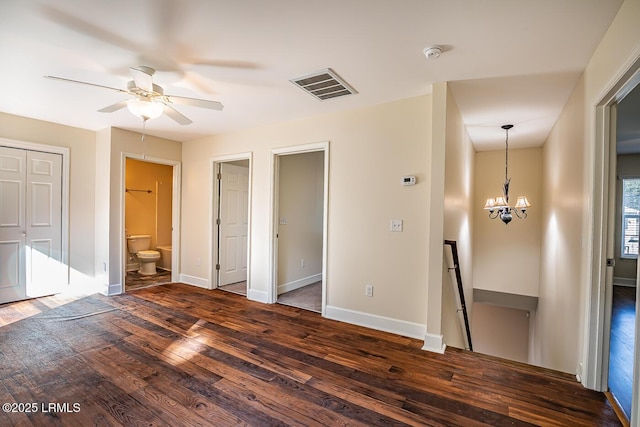 interior space with dark hardwood / wood-style floors and ceiling fan with notable chandelier