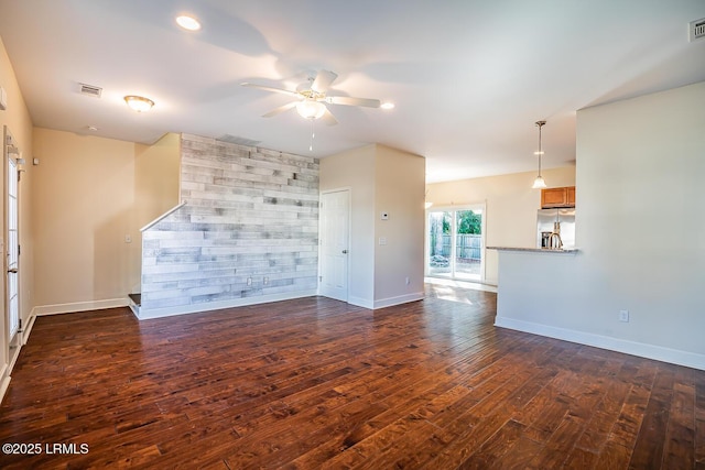 unfurnished living room with ceiling fan and dark hardwood / wood-style flooring