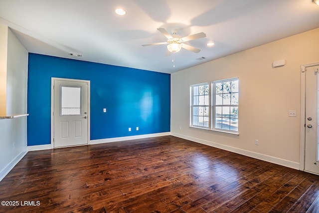 unfurnished room with dark hardwood / wood-style floors and ceiling fan