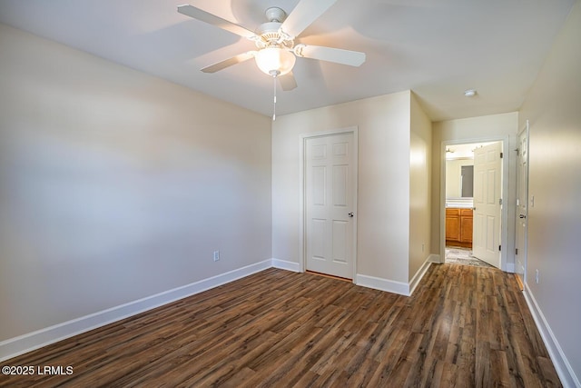 unfurnished bedroom with ceiling fan and dark hardwood / wood-style floors