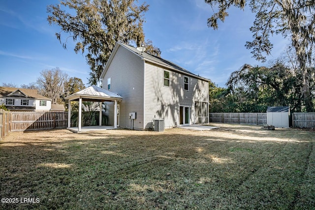 rear view of property with a yard, a gazebo, and a patio