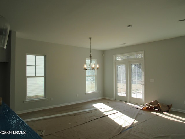 unfurnished dining area with an inviting chandelier