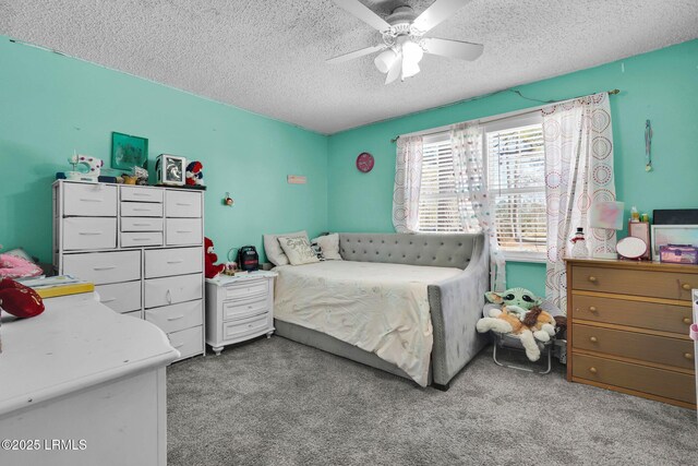 carpeted bedroom featuring a textured ceiling and ceiling fan