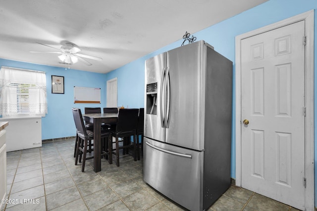 kitchen with tile patterned floors, stainless steel fridge, and ceiling fan