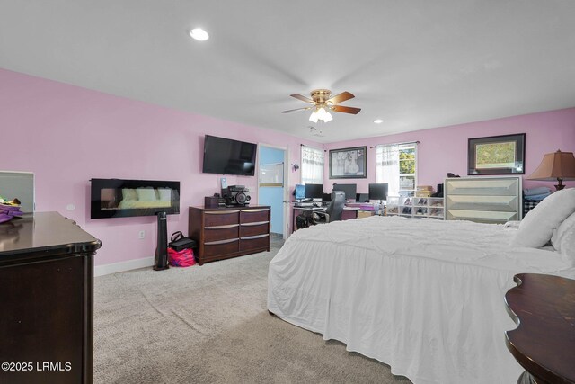 bedroom featuring ceiling fan and light carpet