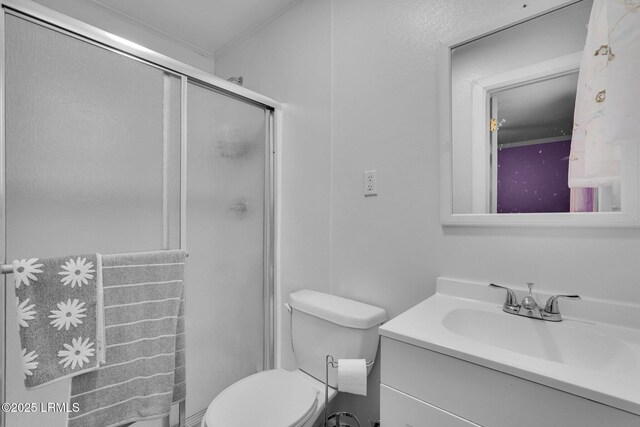 bathroom featuring vanity, toilet, and a shower with shower door