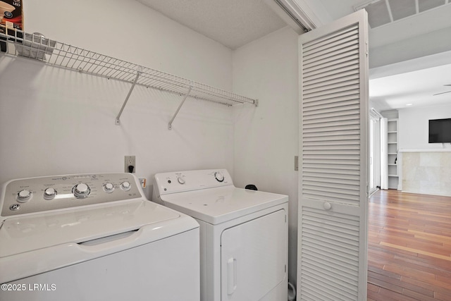 laundry room with separate washer and dryer and wood finished floors